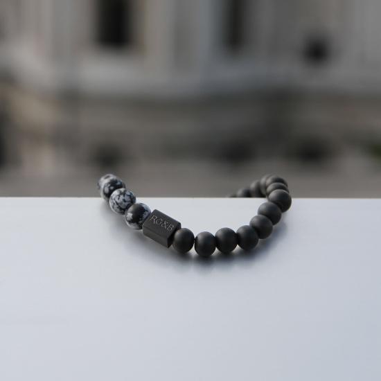 Snowflake Obsidian Bead Bracelet - Our Snowflake Obsidian Bead Bracelet Features 8mm Natural Stones, Premium Elastic Cord and Brushed Black Hardware. A Beautiful Addition to any Collection.